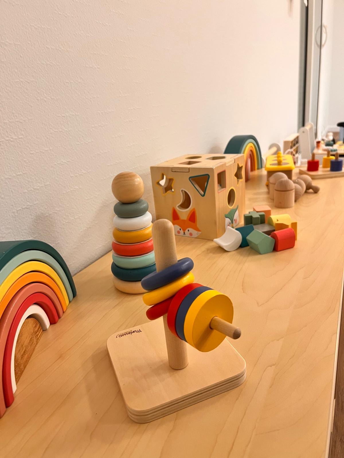 Jouets d’éveil en bois sur étagère à hauteur d’enfant à la micro-crèche Mélisse à Dachstein